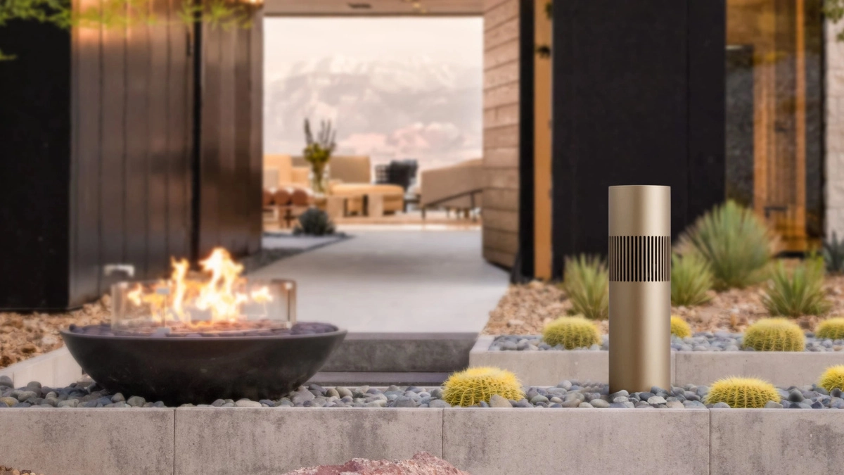 Beosound Bollard jako venkovní sloupkový reproduktor Bang & Olufsen na zahradě